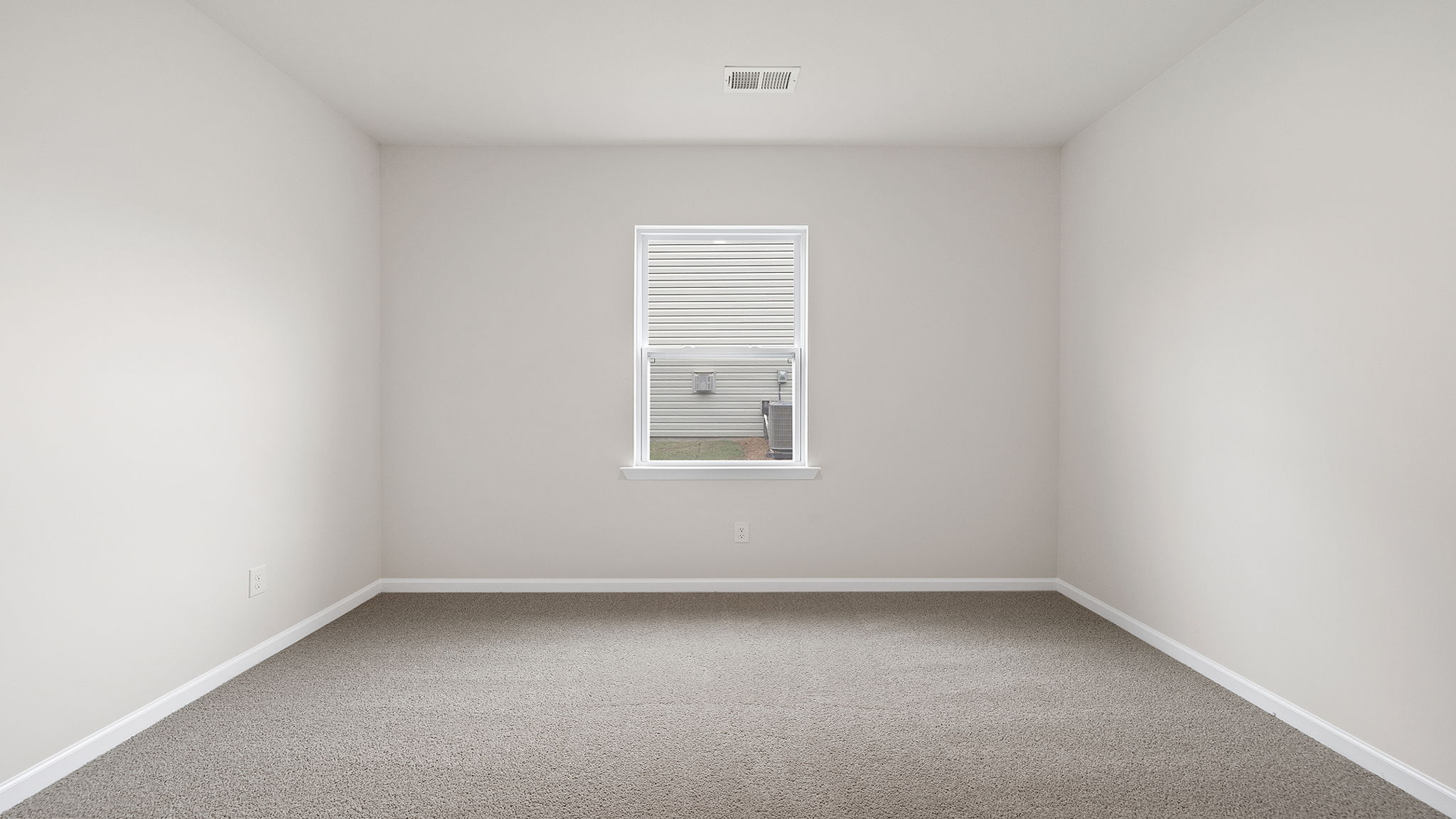 Bedroom with window and carpet.