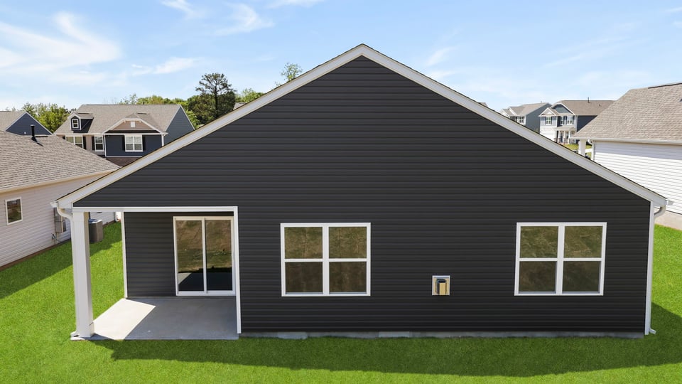 Back exterior with covered patio.