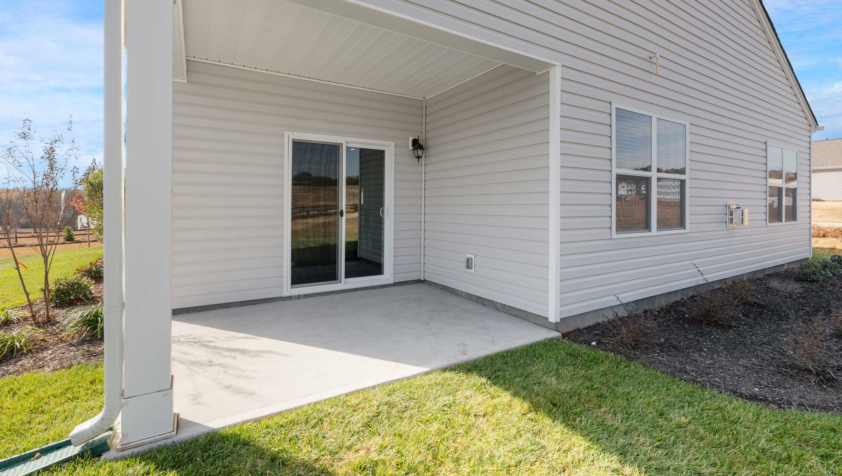 Back exterior with covered patio.