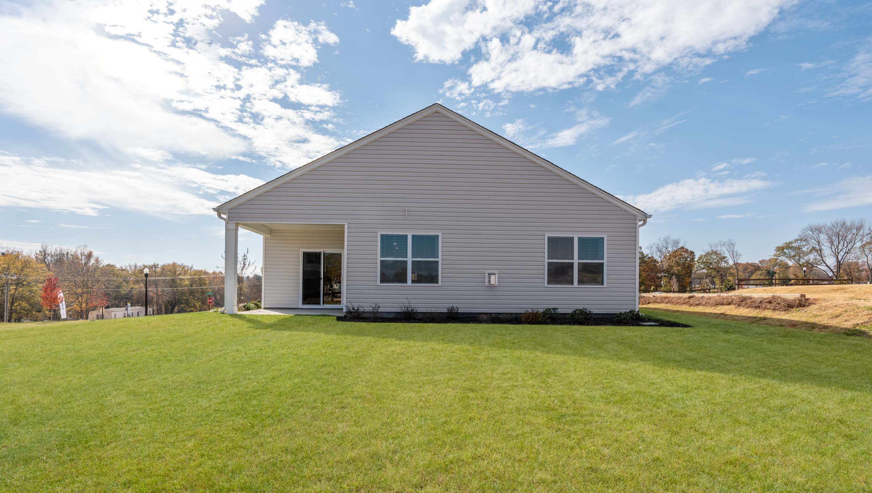 Back exterior with covered patio.
