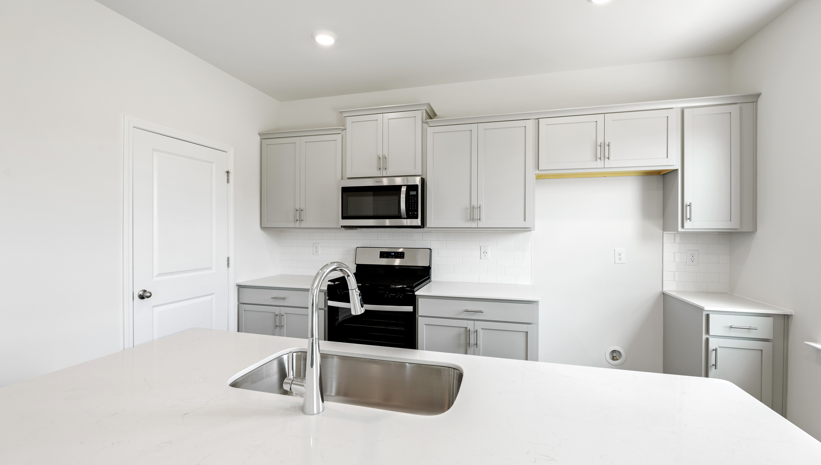 Kitchen has quartz countertops.