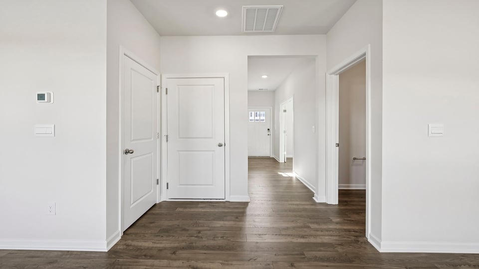 View of hallway from living area toward entrance,
