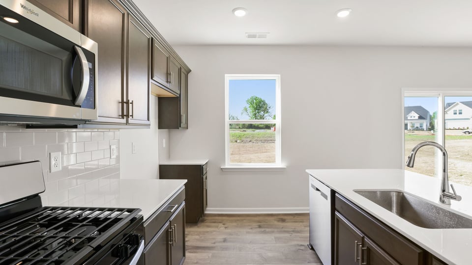 Kitchen with island and cabinets.