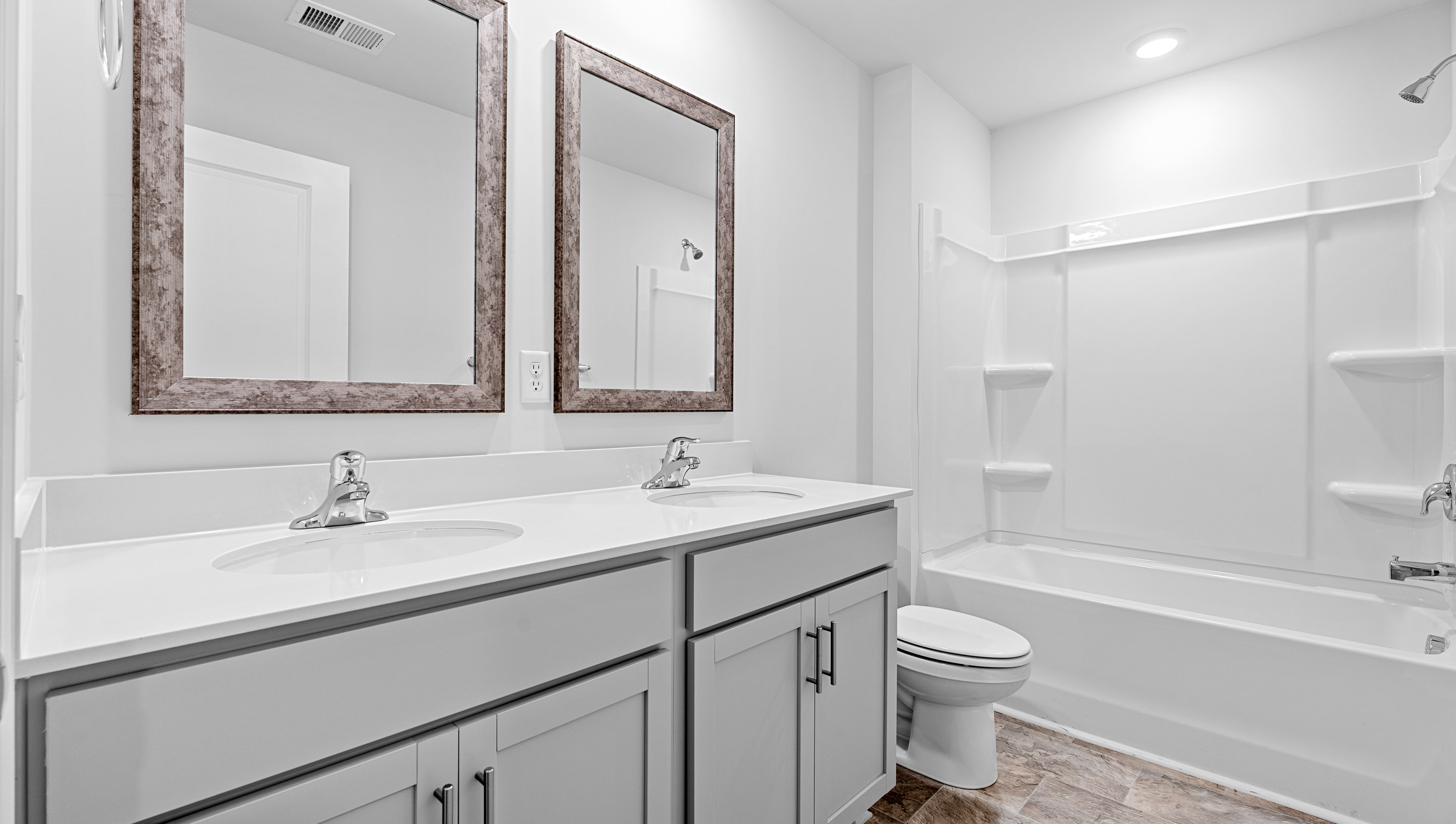 Dual sink vanity and combination shower / tub.