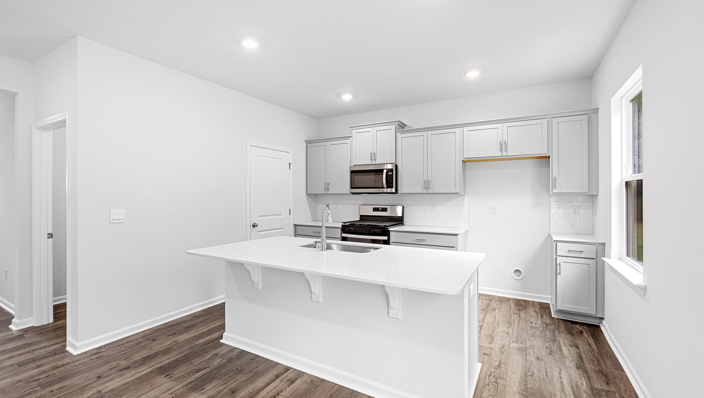 Open kitchen with island and recessed lighting.