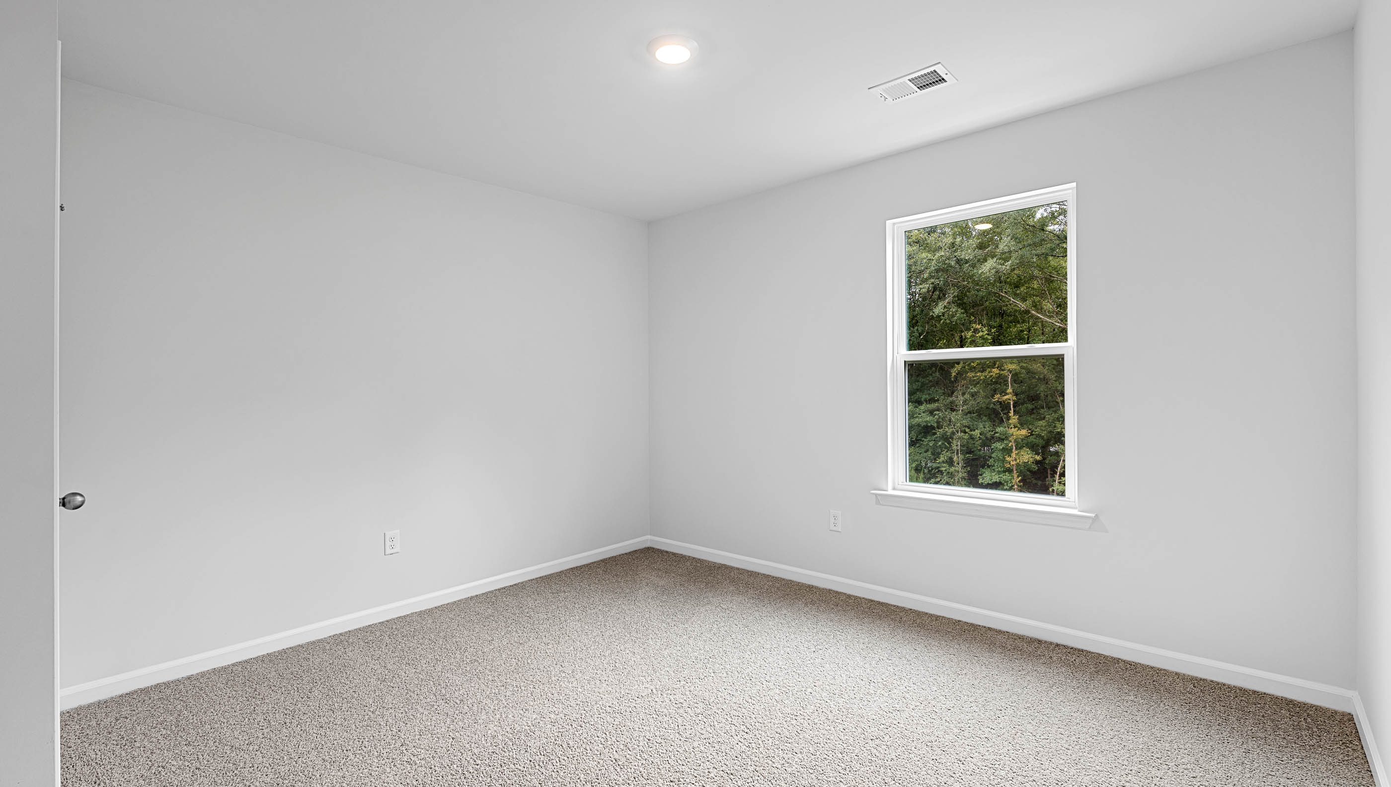 Bedroom with window and carpet.