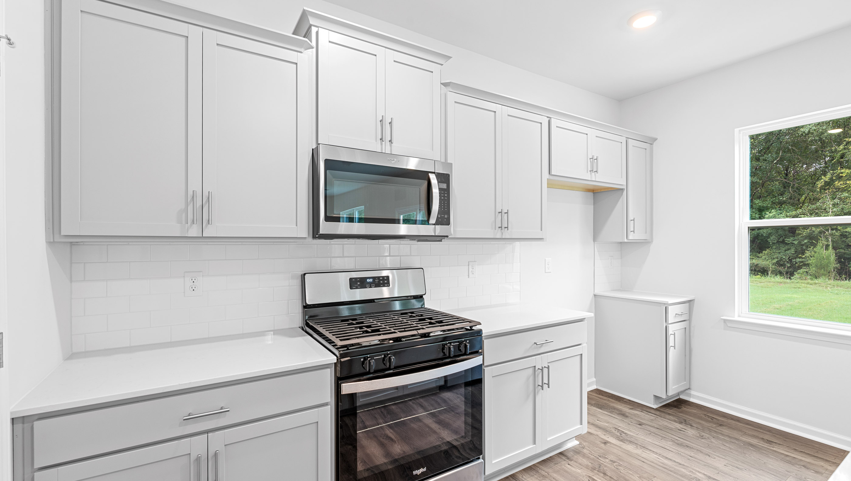 Island and kitchen have quartz countertops.