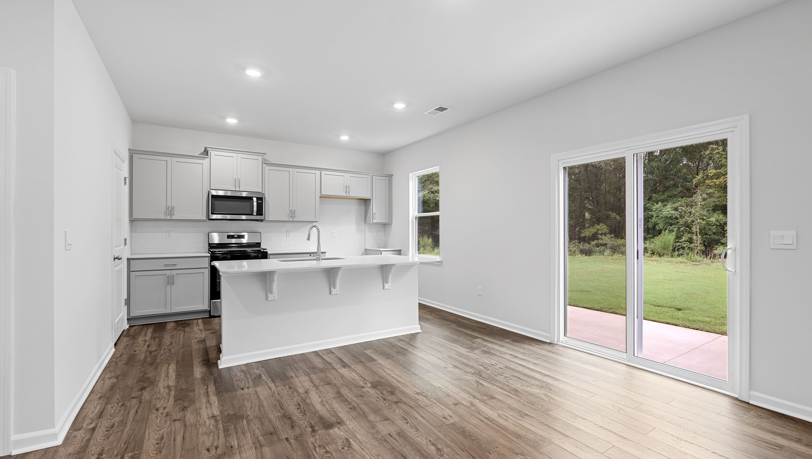 View of kitchen and notice the stainless steel appliances and doors to the back yard.