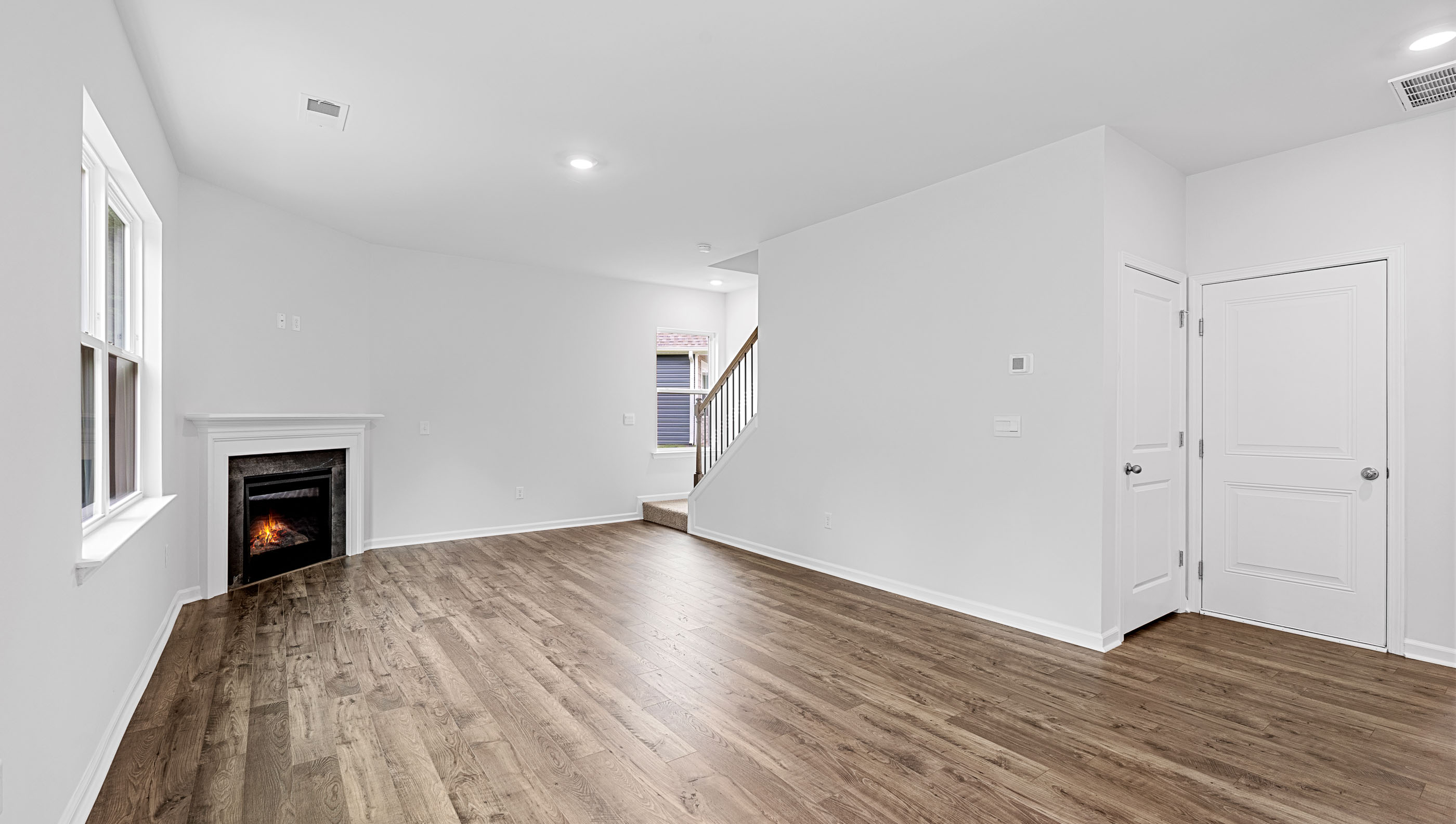 Family room has lots of windows and a gas log fireplace.