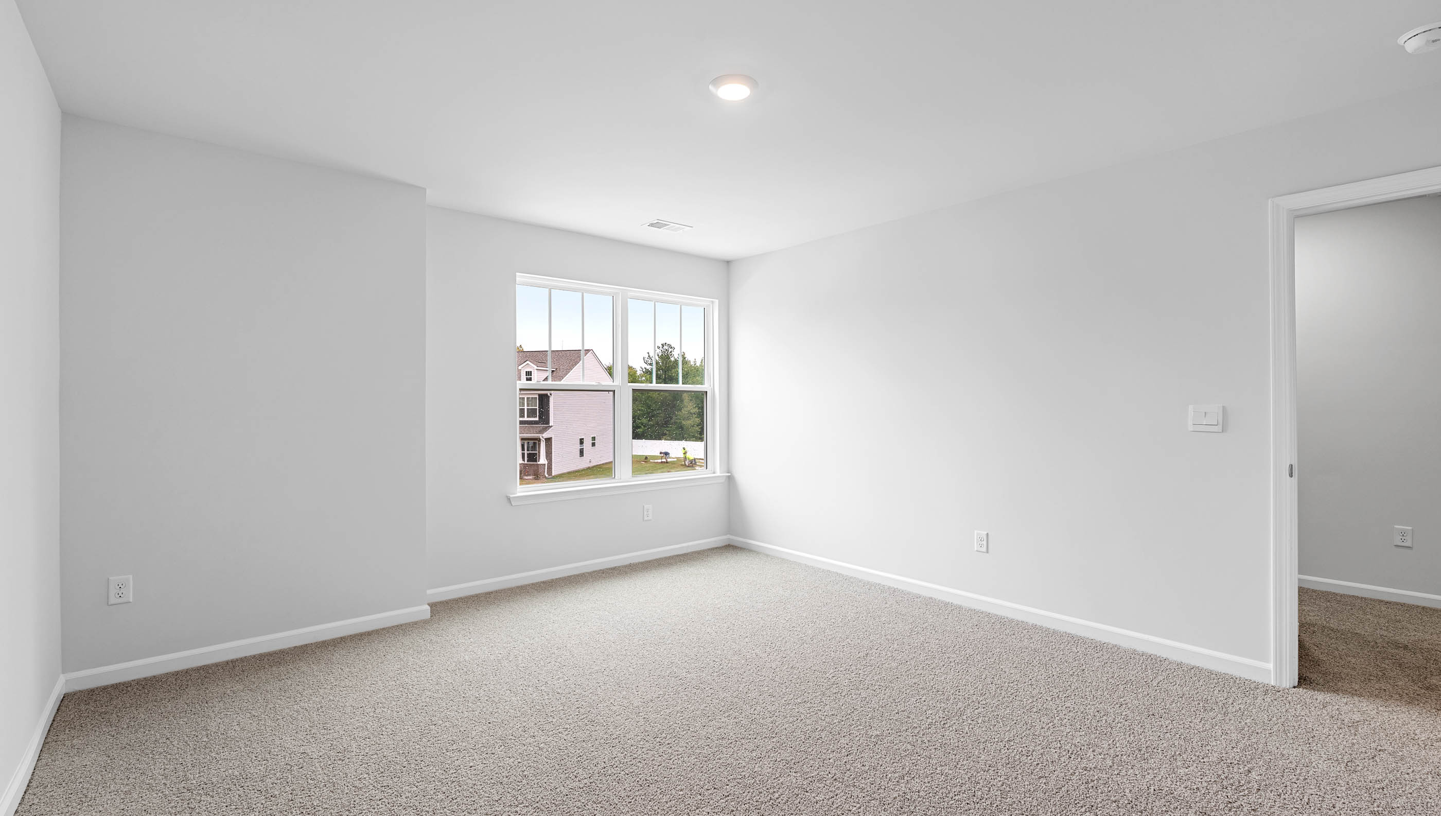 Bedroom with window and carpet.