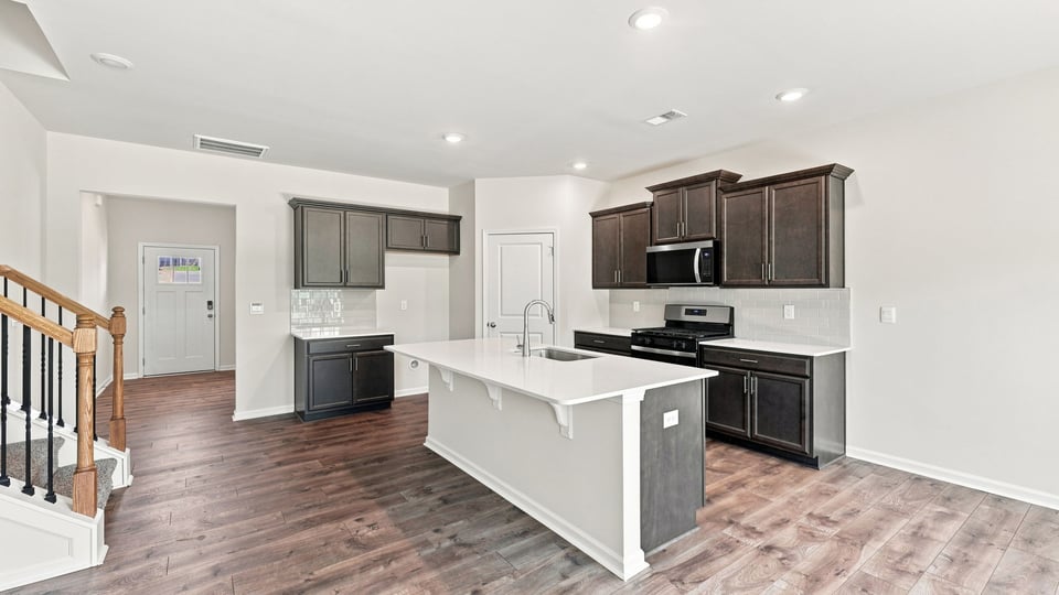 Kitchen with island and cabinets.