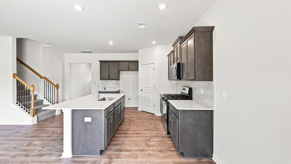 Kitchen with island and cabinets.