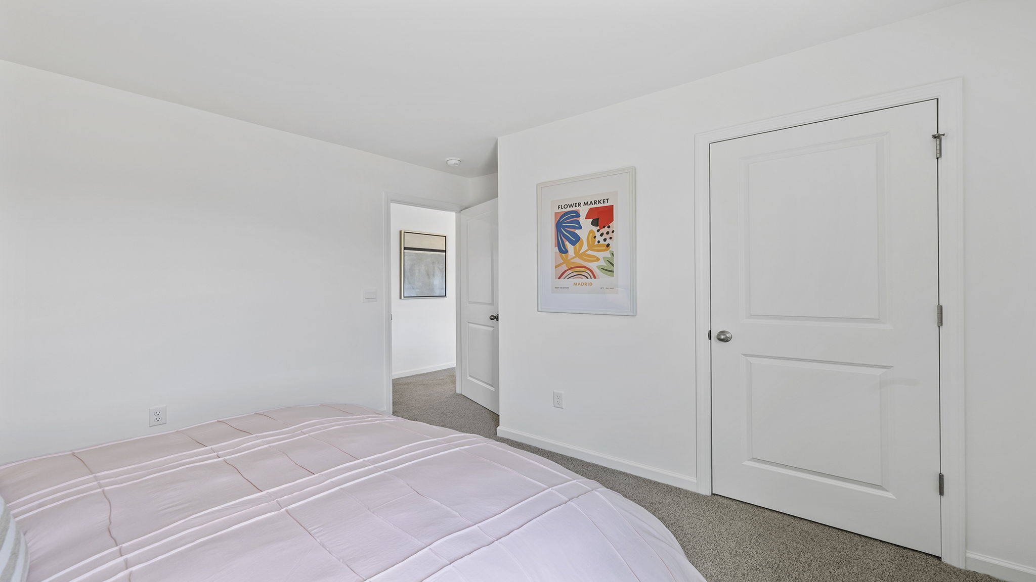 Bedroom with carpet and window.