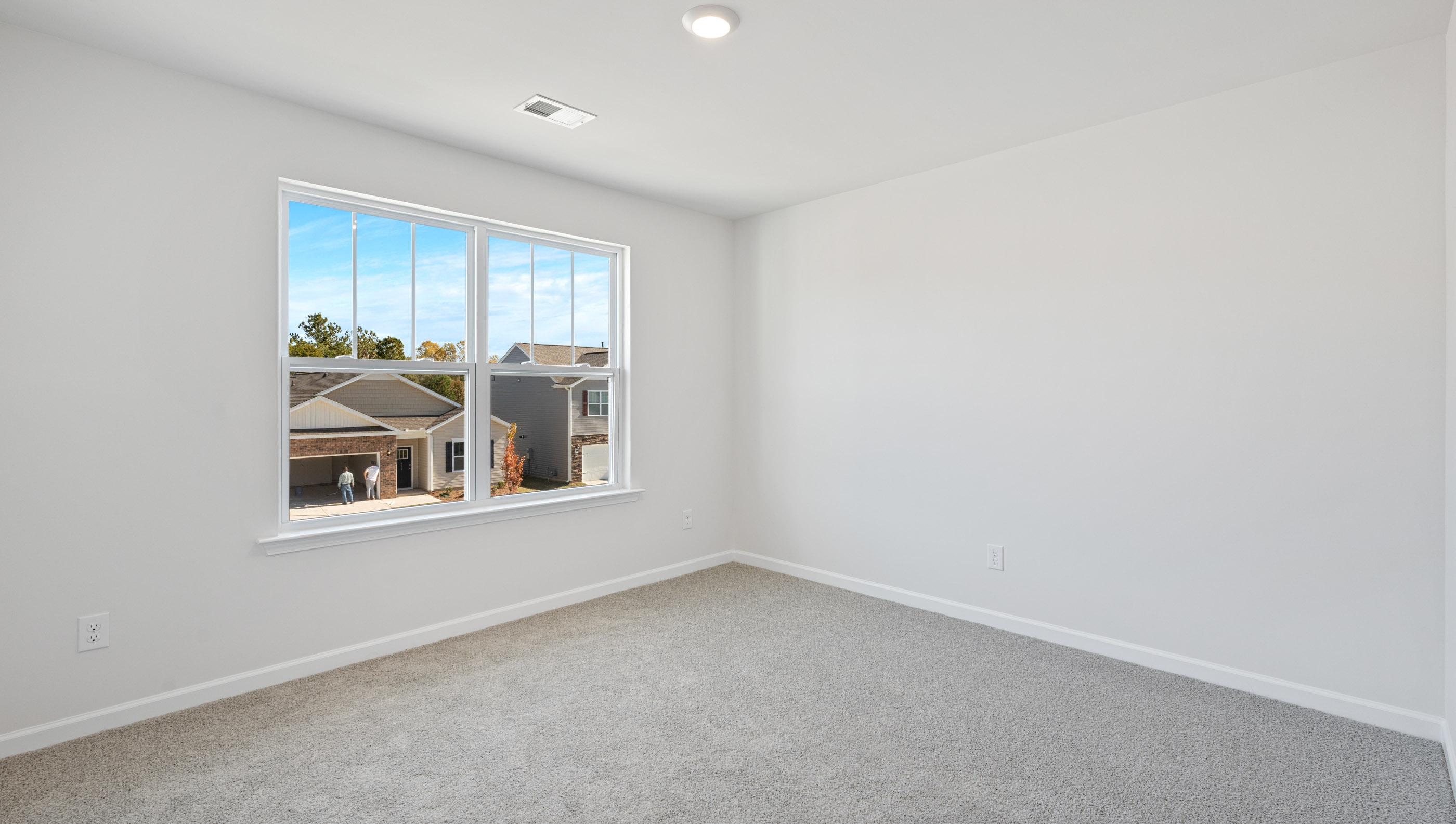 Bedroom with double window and carpet.