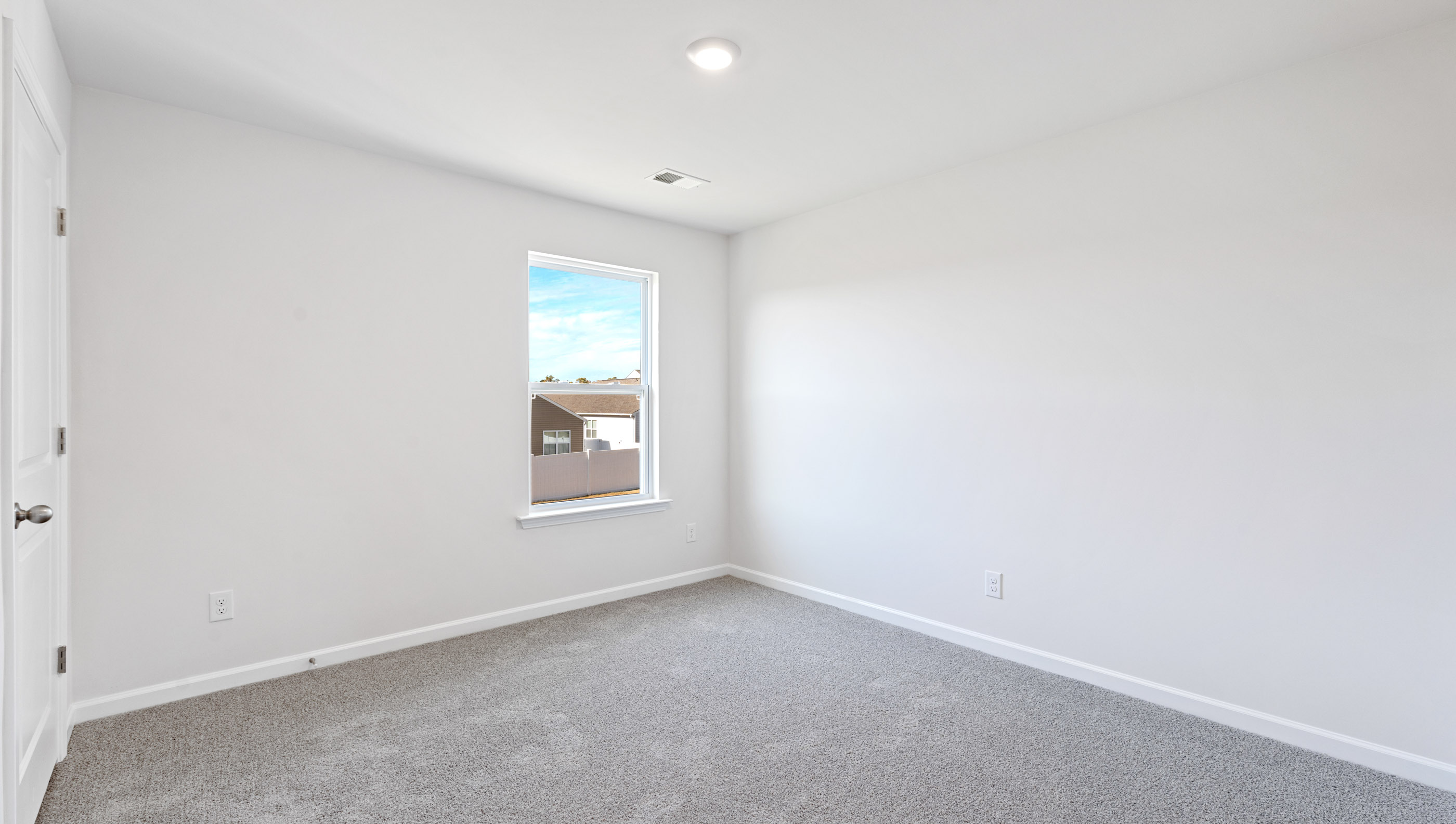 Bedroom with window and carpet.