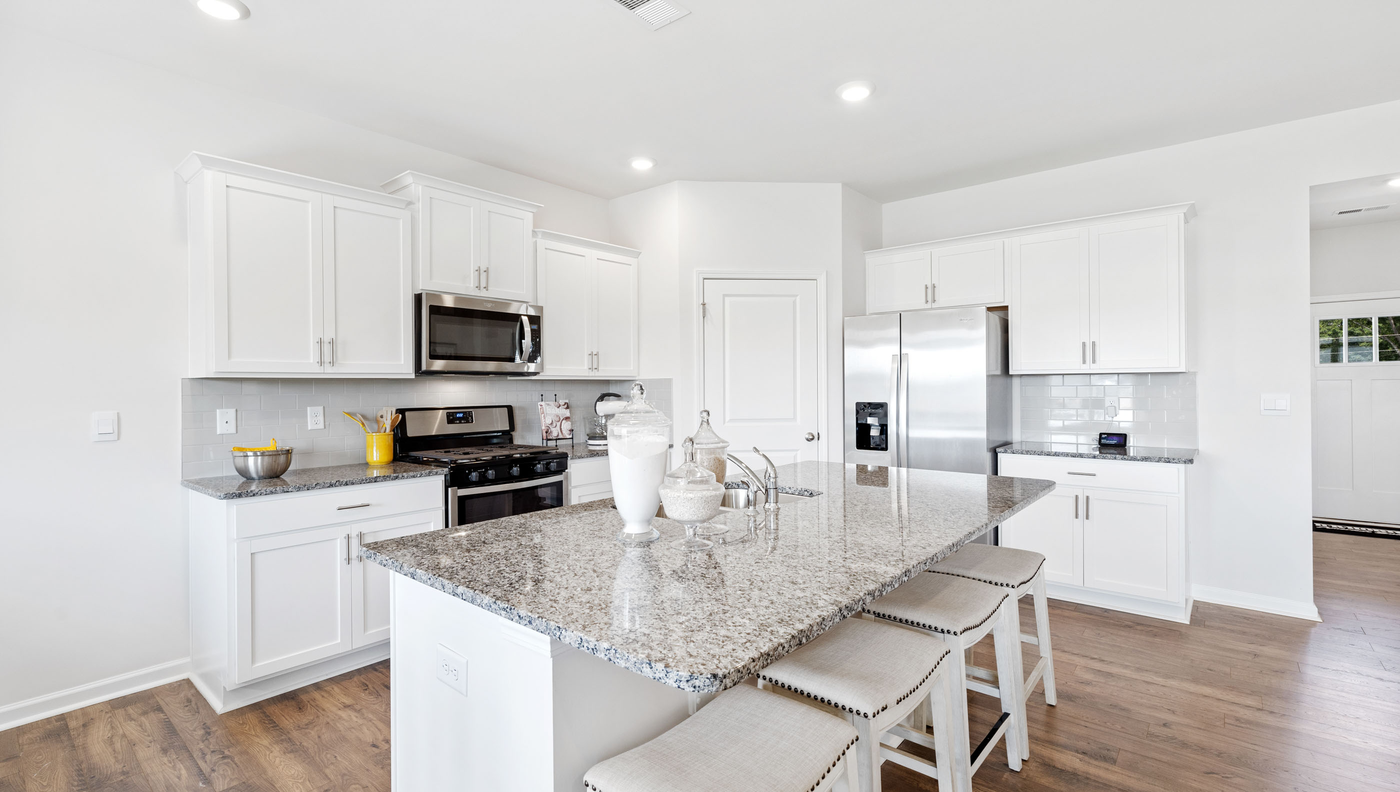 Kitchen and island with granite counter tops.
