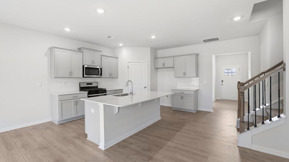 Kitchen with island and cabinets.