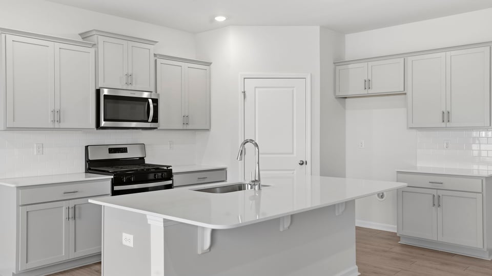 Kitchen with island and cabinets.