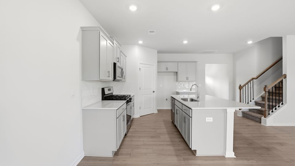 Kitchen with island and cabinets.
