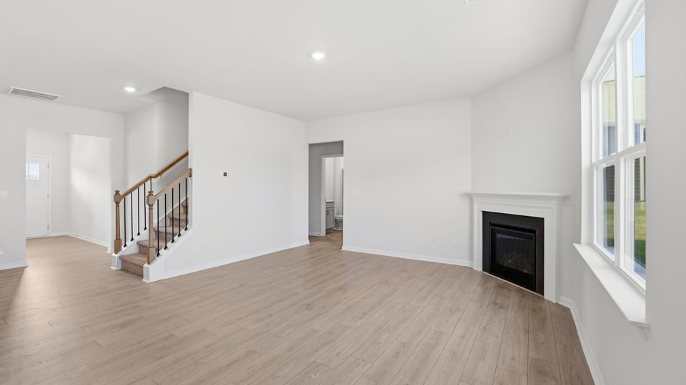 Living room with fireplace and windows.