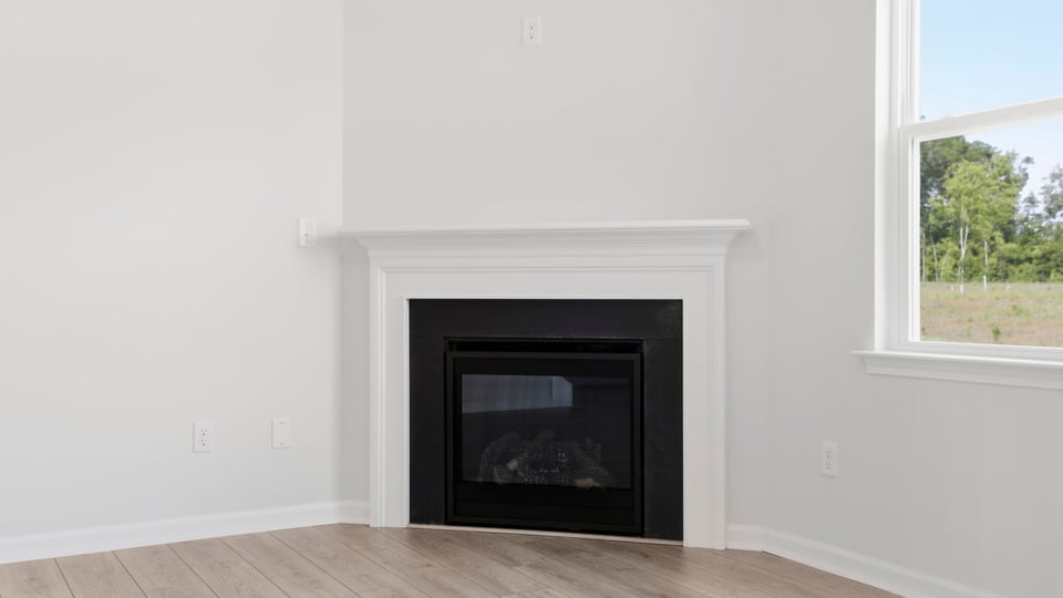 Living room with fireplace and windows.