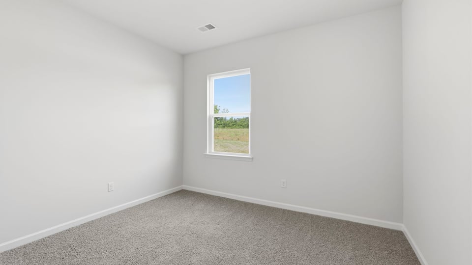 Bedroom with carpet and windows.