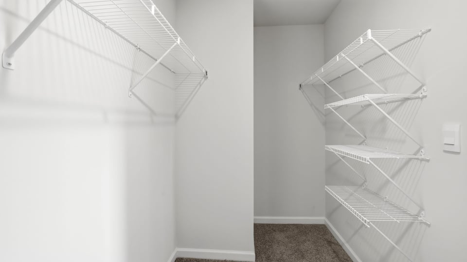 Primary closet with shelf.