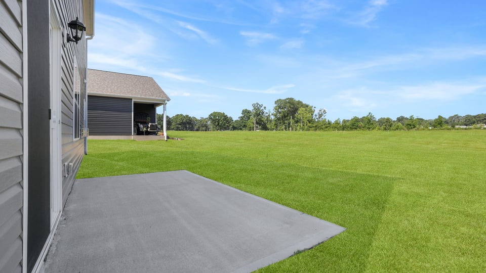 Back exterior with large backyard.