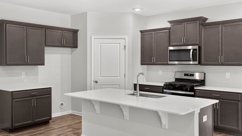 Kitchen and island with quartz countertops.
