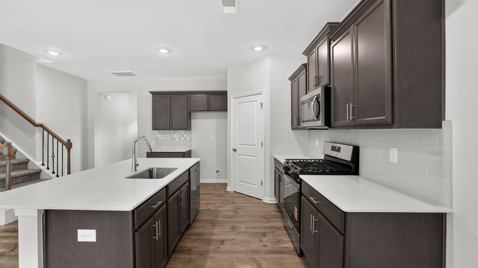 Kitchen and island with quartz countertops.