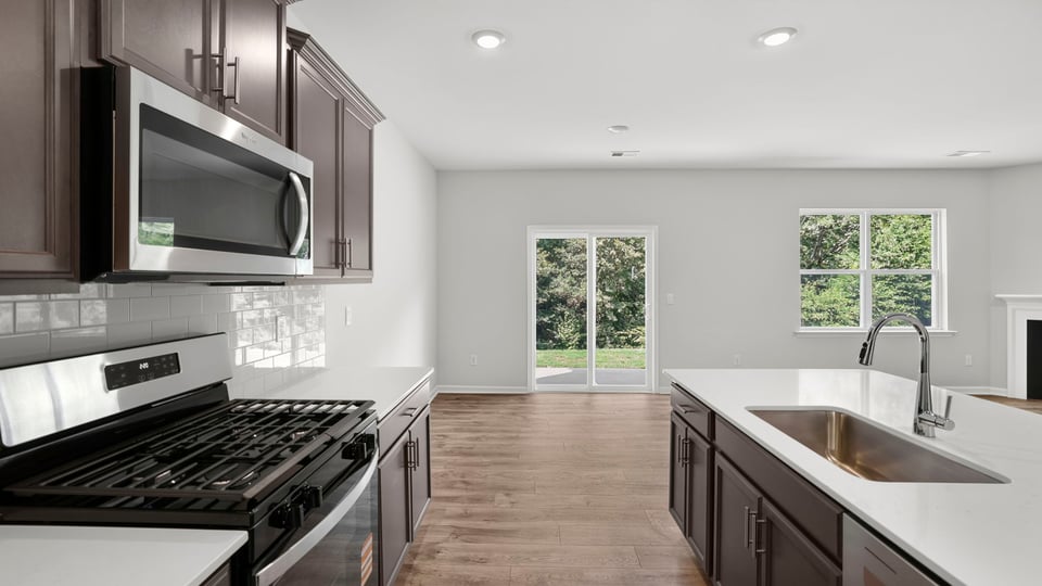 Kitchen and island with quartz countertops.
