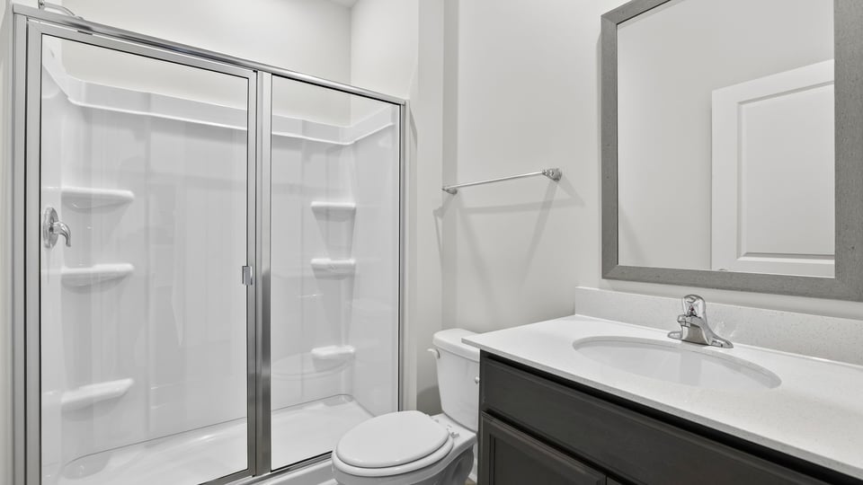 Bathroom with single vanity sink and walk in shower.