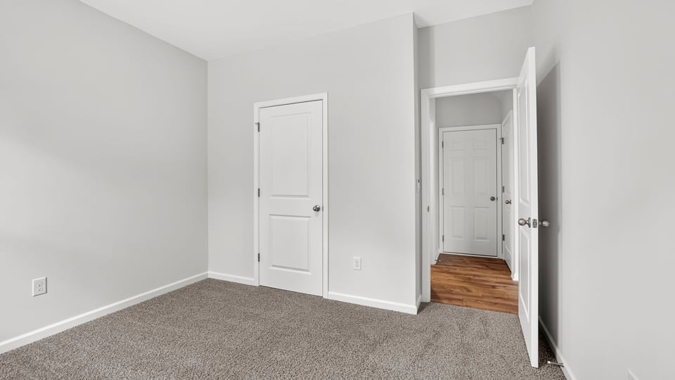 Bedroom with carpet and window.