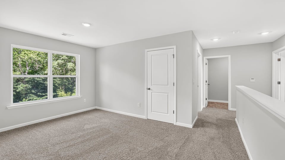 Bedroom with carpet and window.
