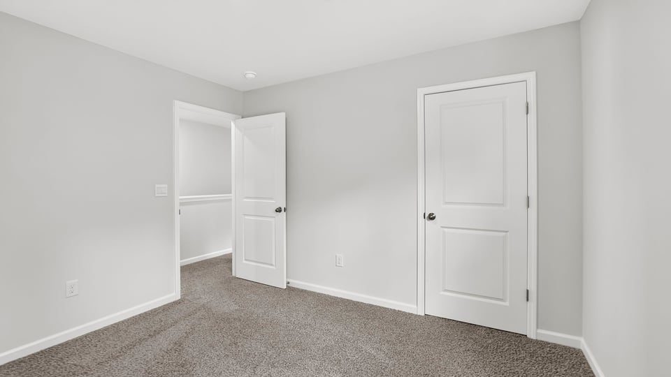 Bedroom with carpet and window.