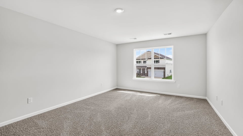 Bedroom with carpet and window.