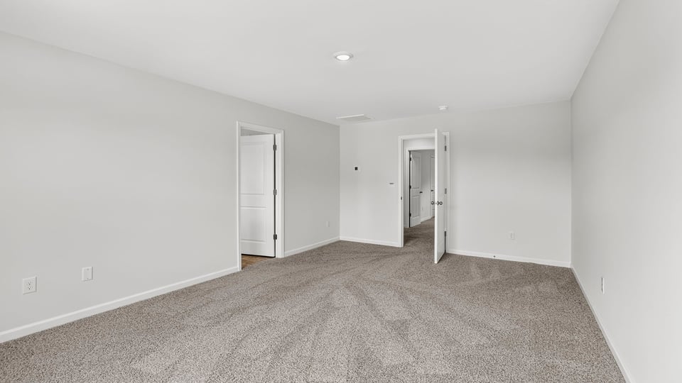 Bedroom with carpet and window.