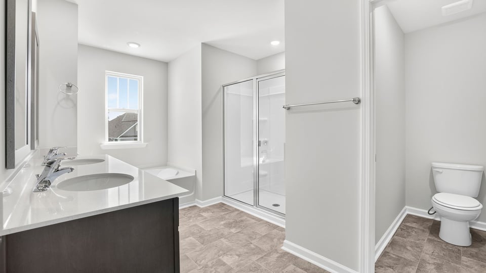 Bathroom with double vanity sink and closet.