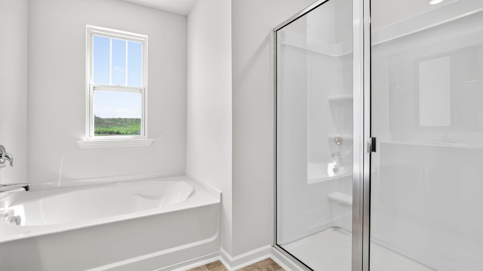 Bathroom with bathtub and walk in shower.