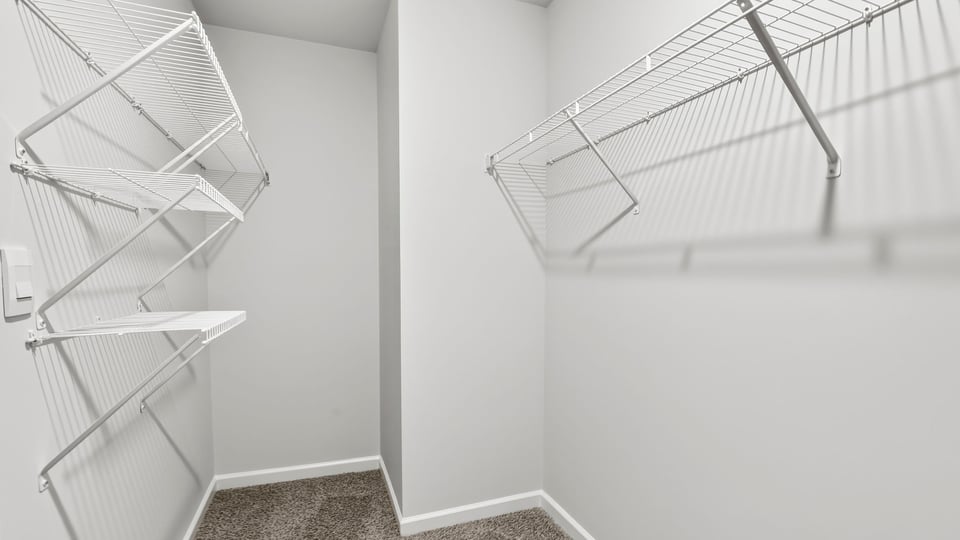 Closet with hanging storage racks.