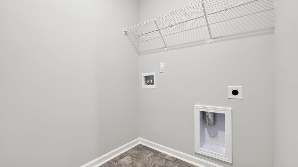 Laundry room with hanging storage racks.