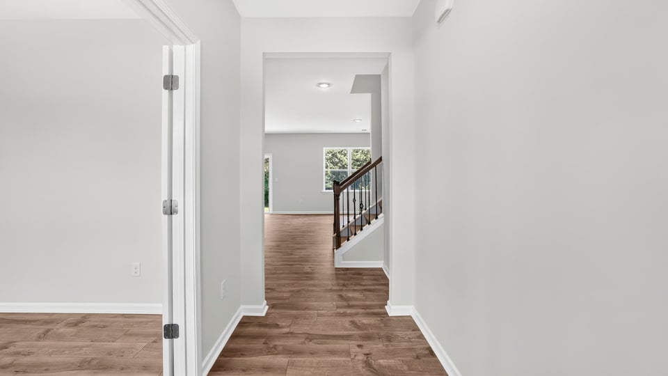 Hallway into home with view of rooms.