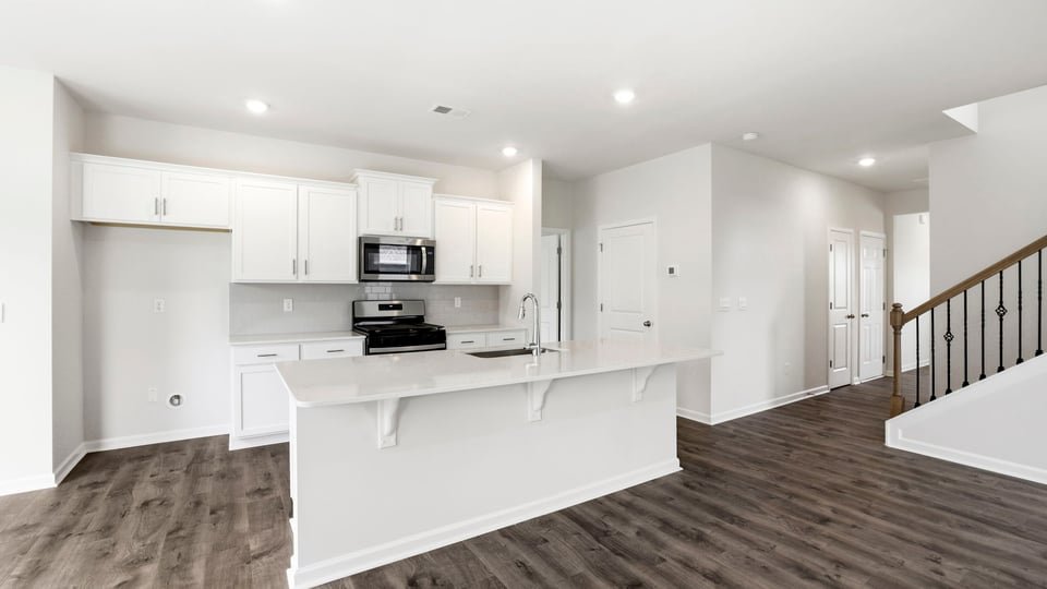 Kitchen and island with stainless steel appliances.