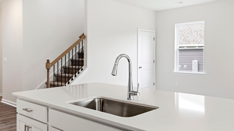 Kitchen and island with stainless steel appliances.