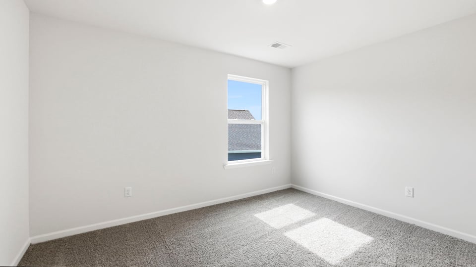 Bedroom with carpet and window.