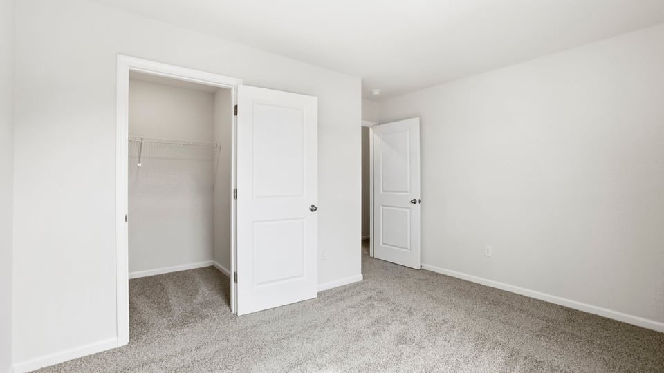 Bedroom with carpet and window.