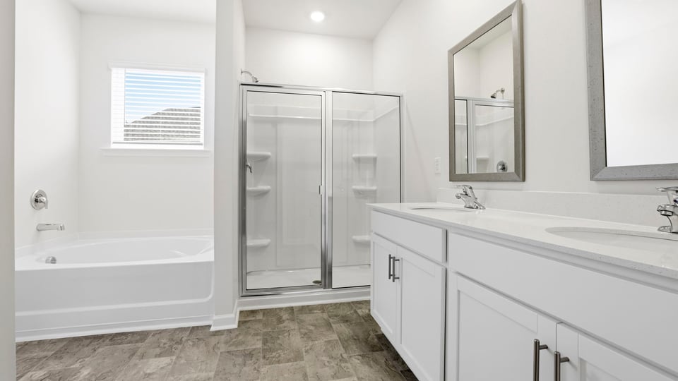 Bathroom with walk in shower and bathtub.