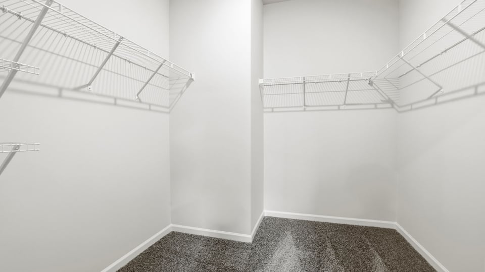Closet with hanging storage racks.