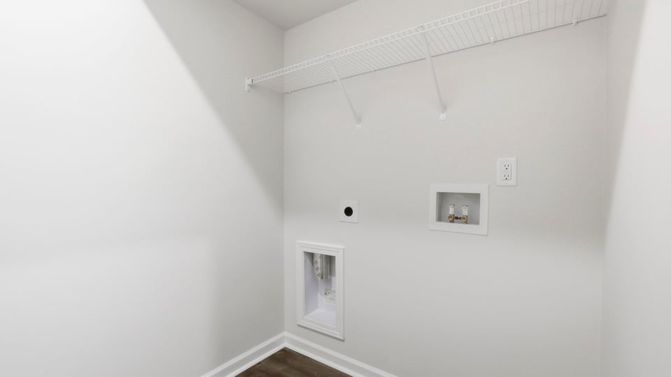 Laundry room with hanging storage racks.