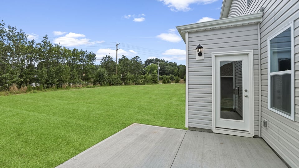 Back exterior of home with patio.